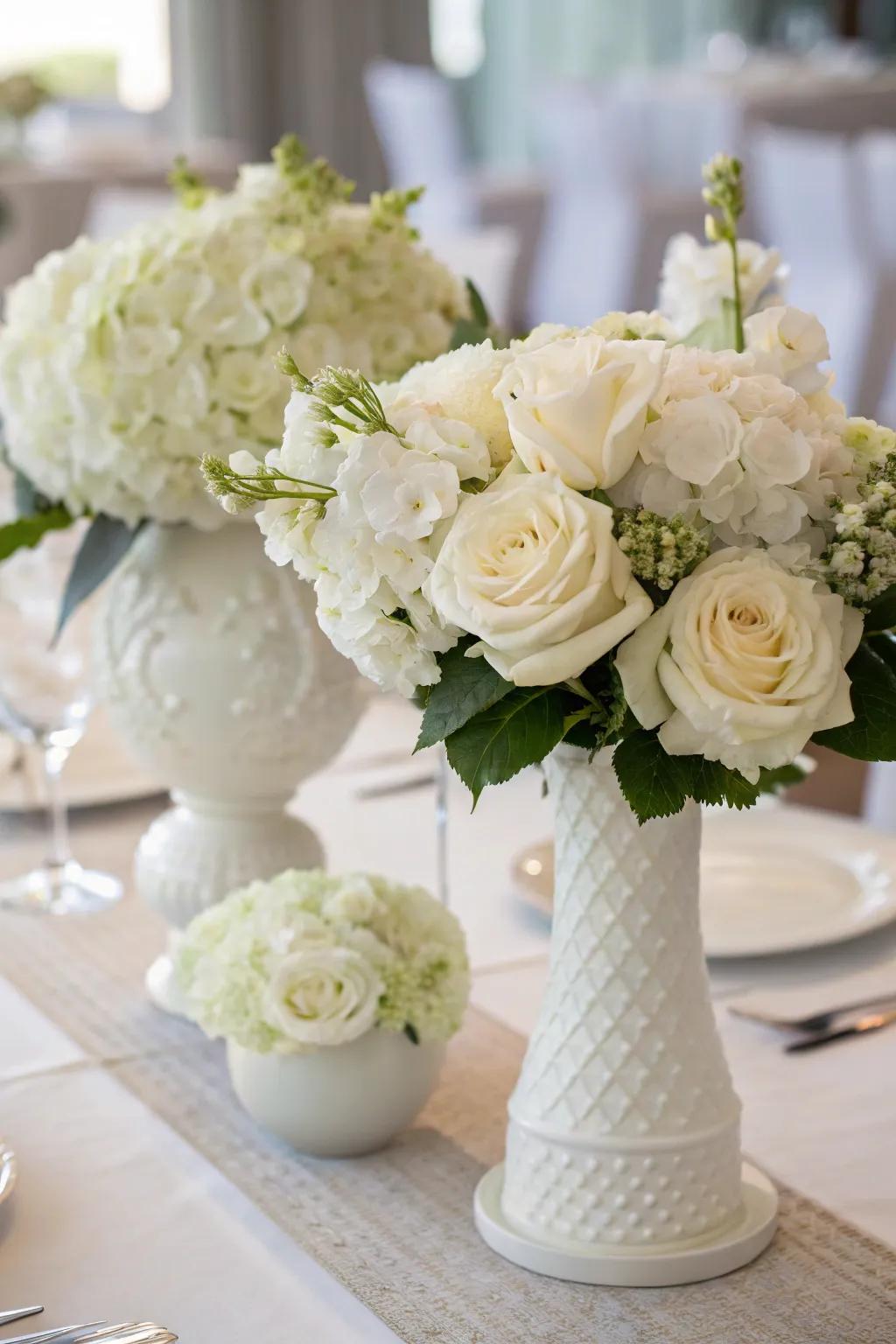 White flowers craft a breathtaking focal point for an all-white dinner setting.