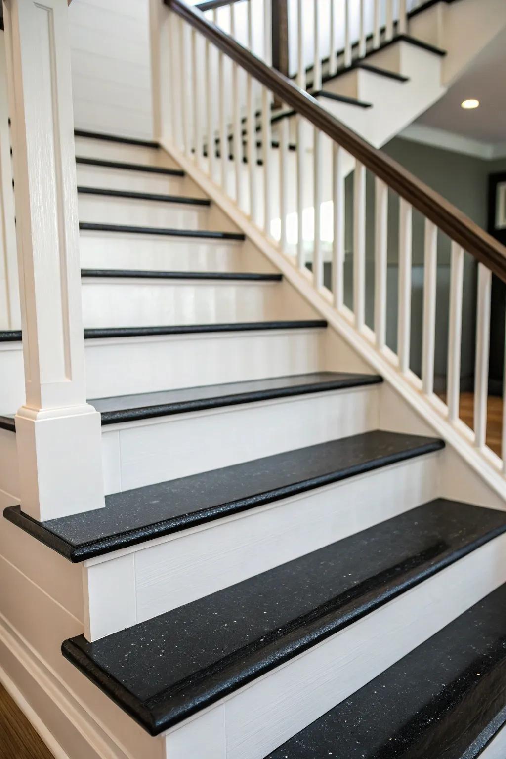 A contemporary staircase featuring dark steps and light elevations for a dramatic contrast.