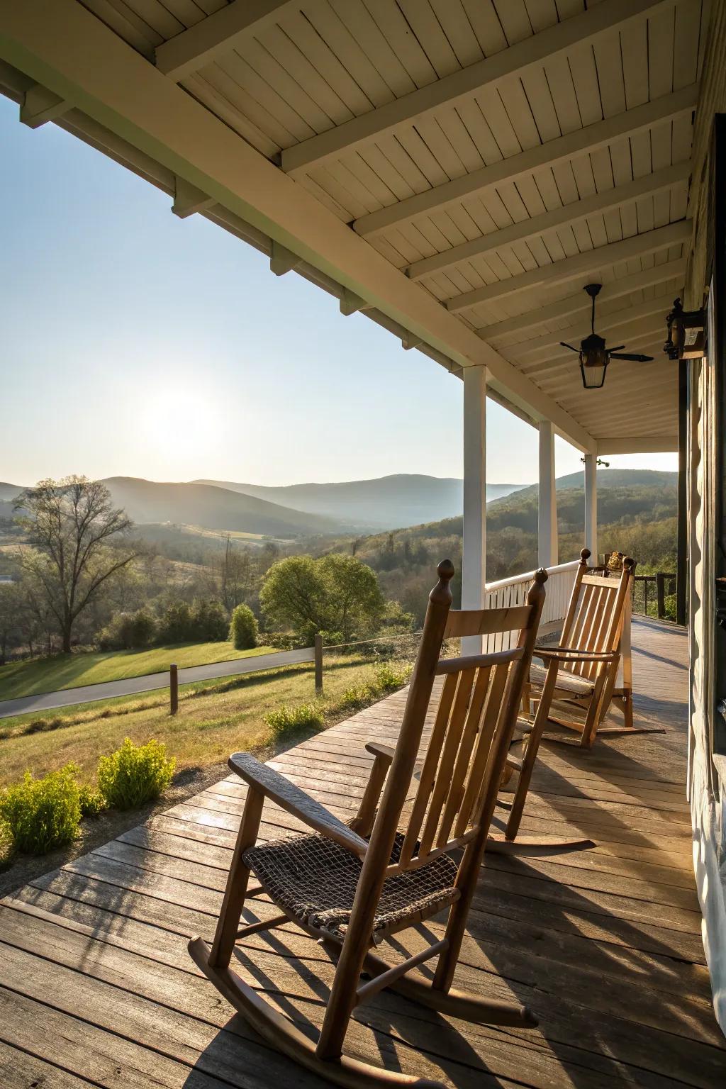 Traditional wooden rocking chairs glow in the morning light on a rural farmhouse porch.