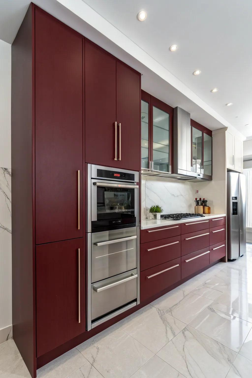 Minimalist kitchen featuring handle-free, deep crimson cabinets.