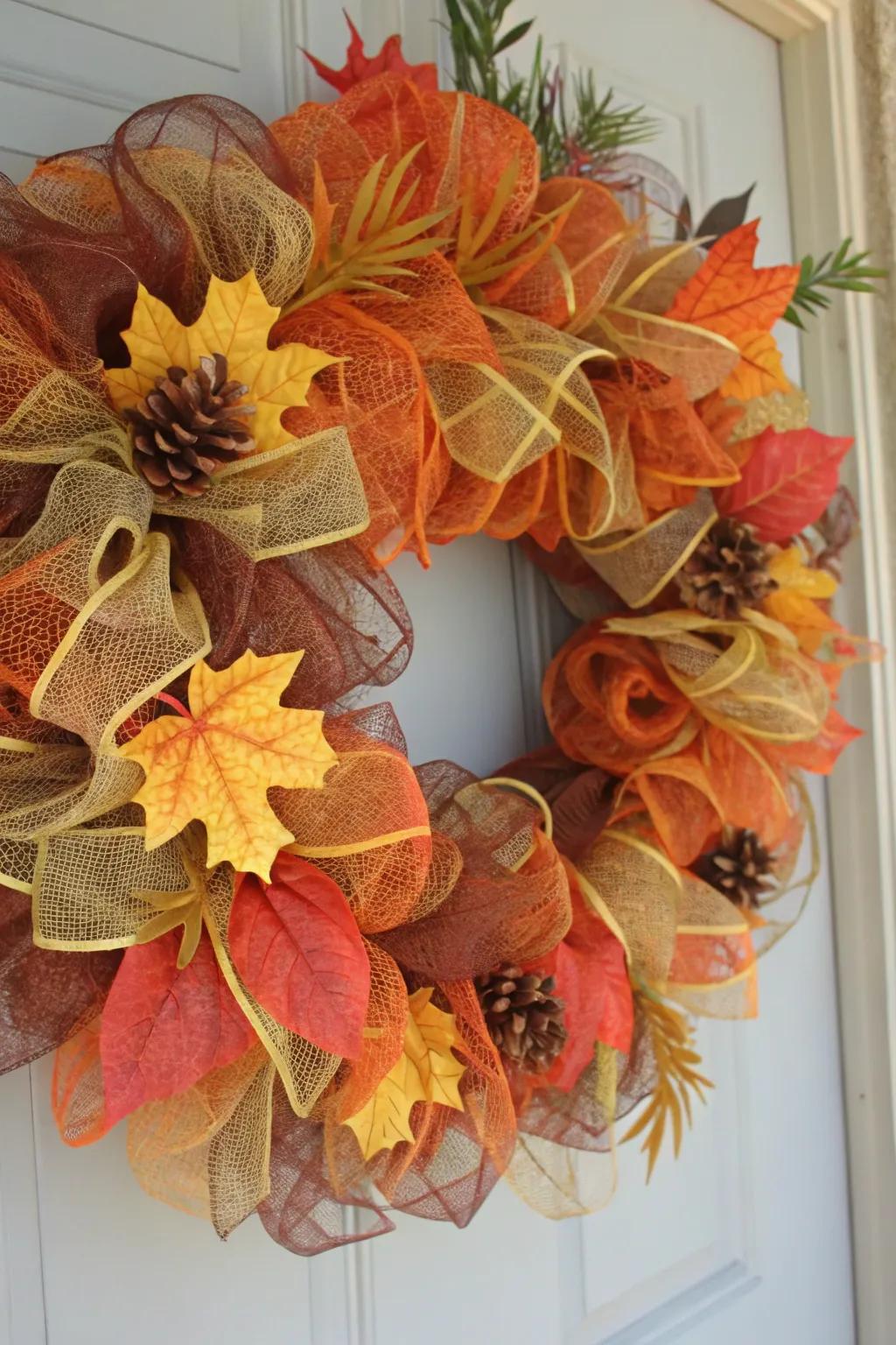 A timeless autumn-toned wreath featuring deco mesh and fall foliage.