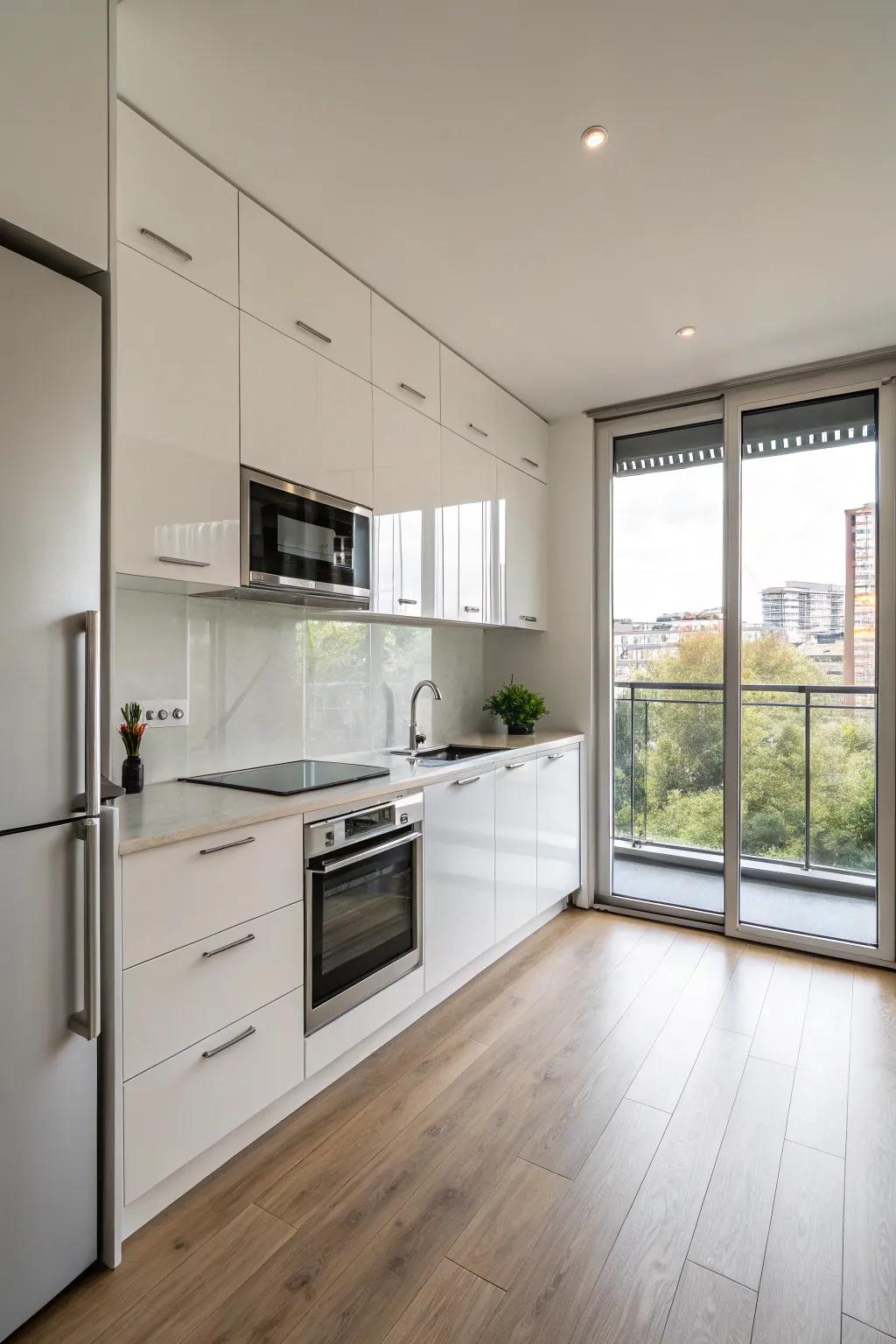 A minimalist single-wall kitchen flaunting reflective units and steel fixtures.