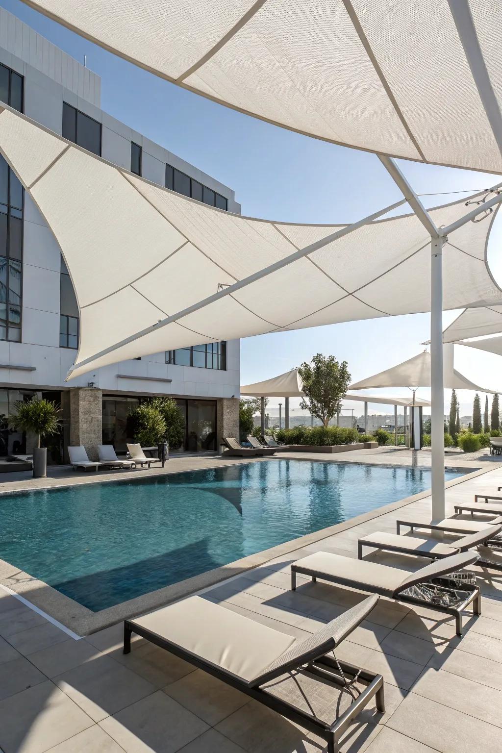 Contemporary shade sails elegantly shield from sunlight.