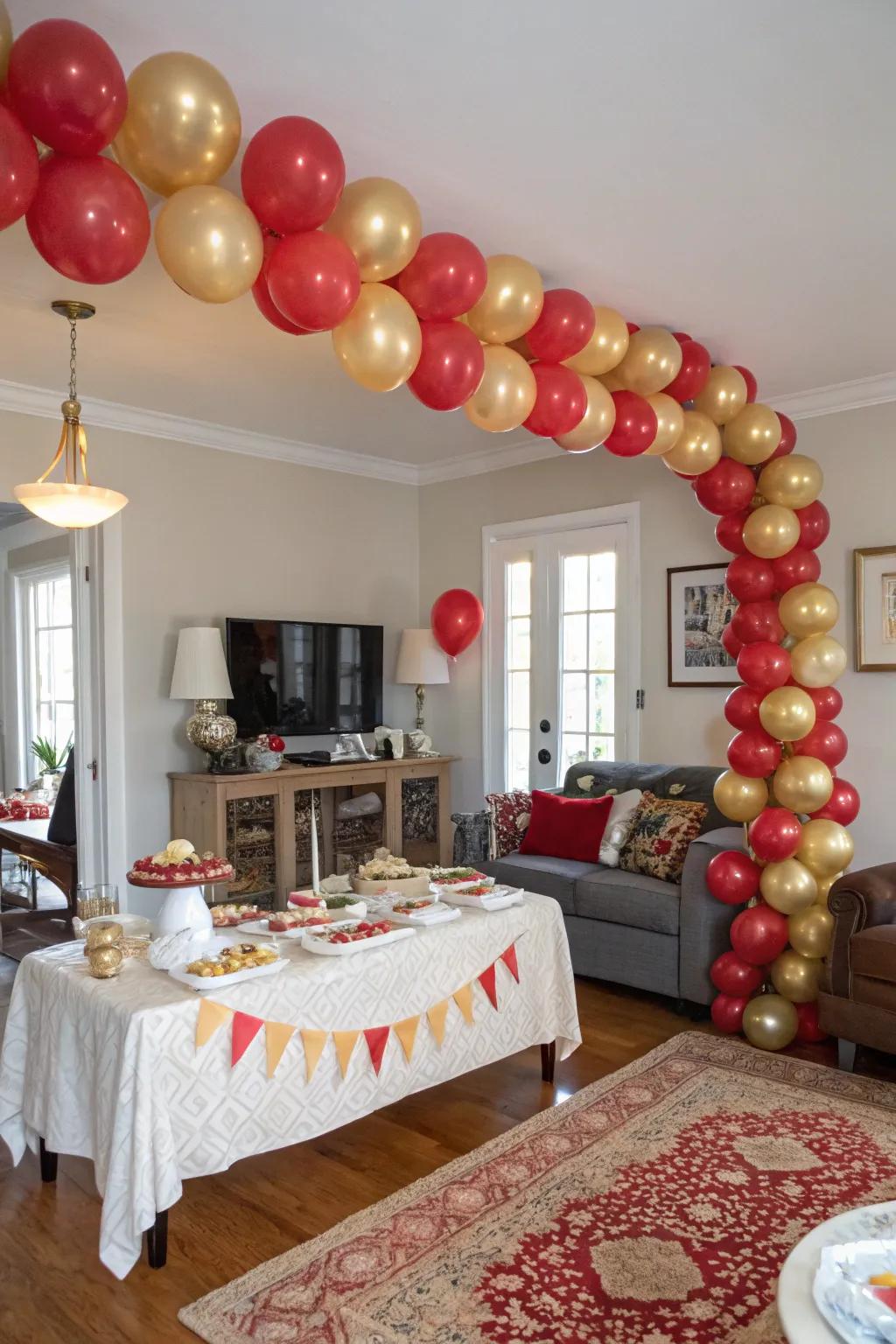 A beautiful scarlet and gilded balloon arch makes for a captivating entrance.