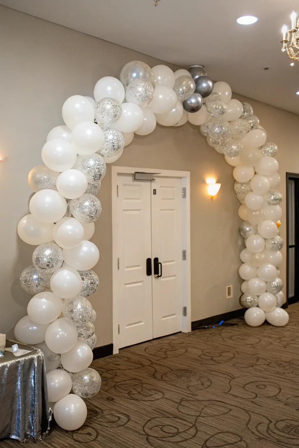 Celebrate stylishly with a captivating white and silver festoon arch.