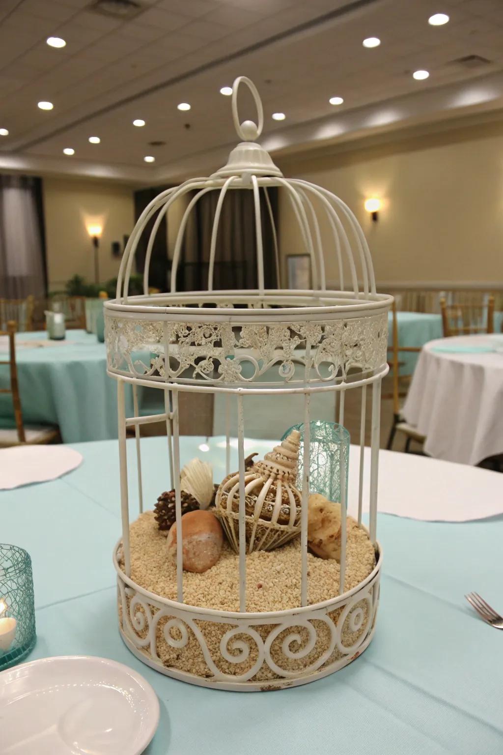 A coastal-themed bird cage centerpiece featuring beachy components.