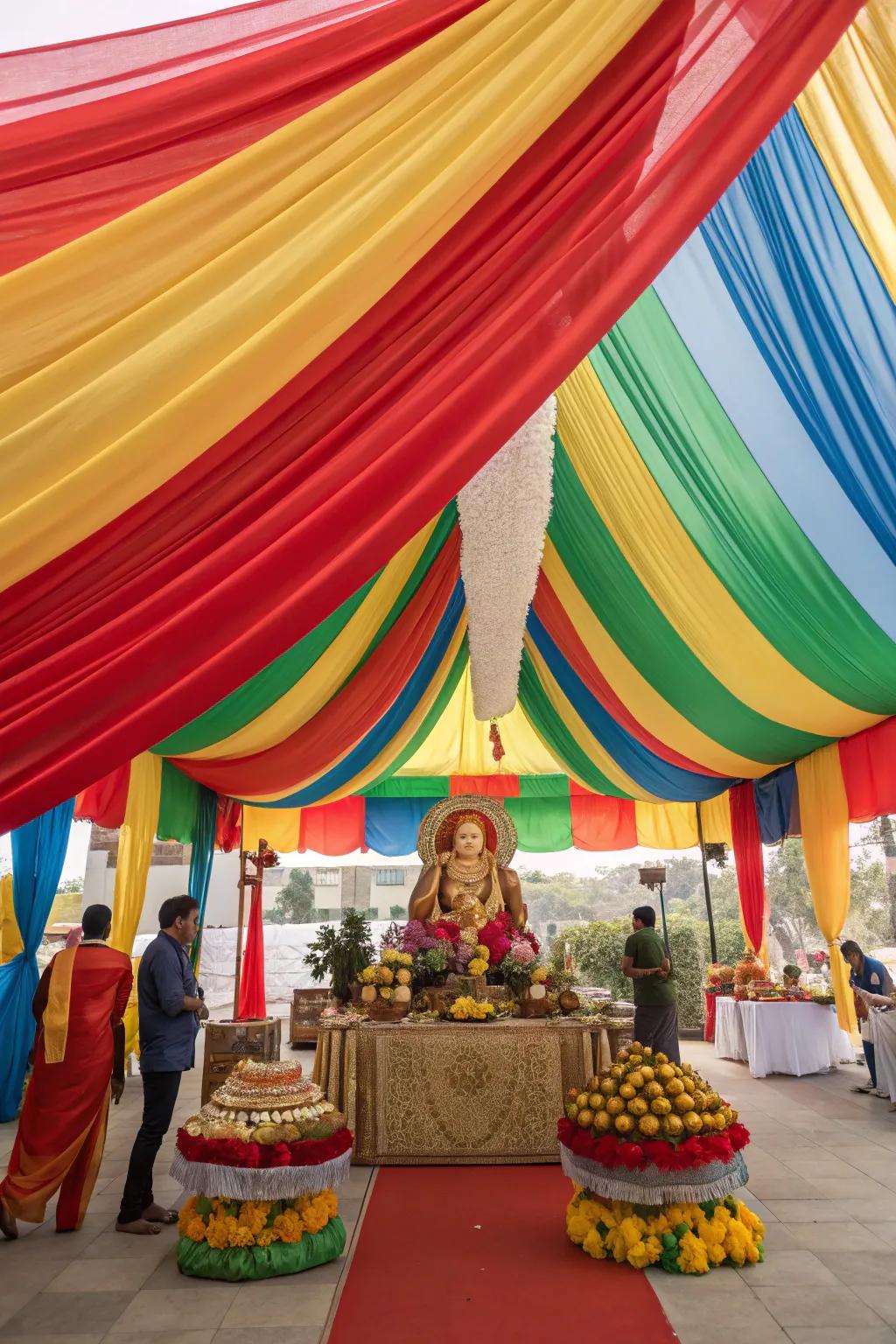 Dramatic and kaleidoscopic drapes constructing a canopy above the Ganesh Chaturthi arrangement.