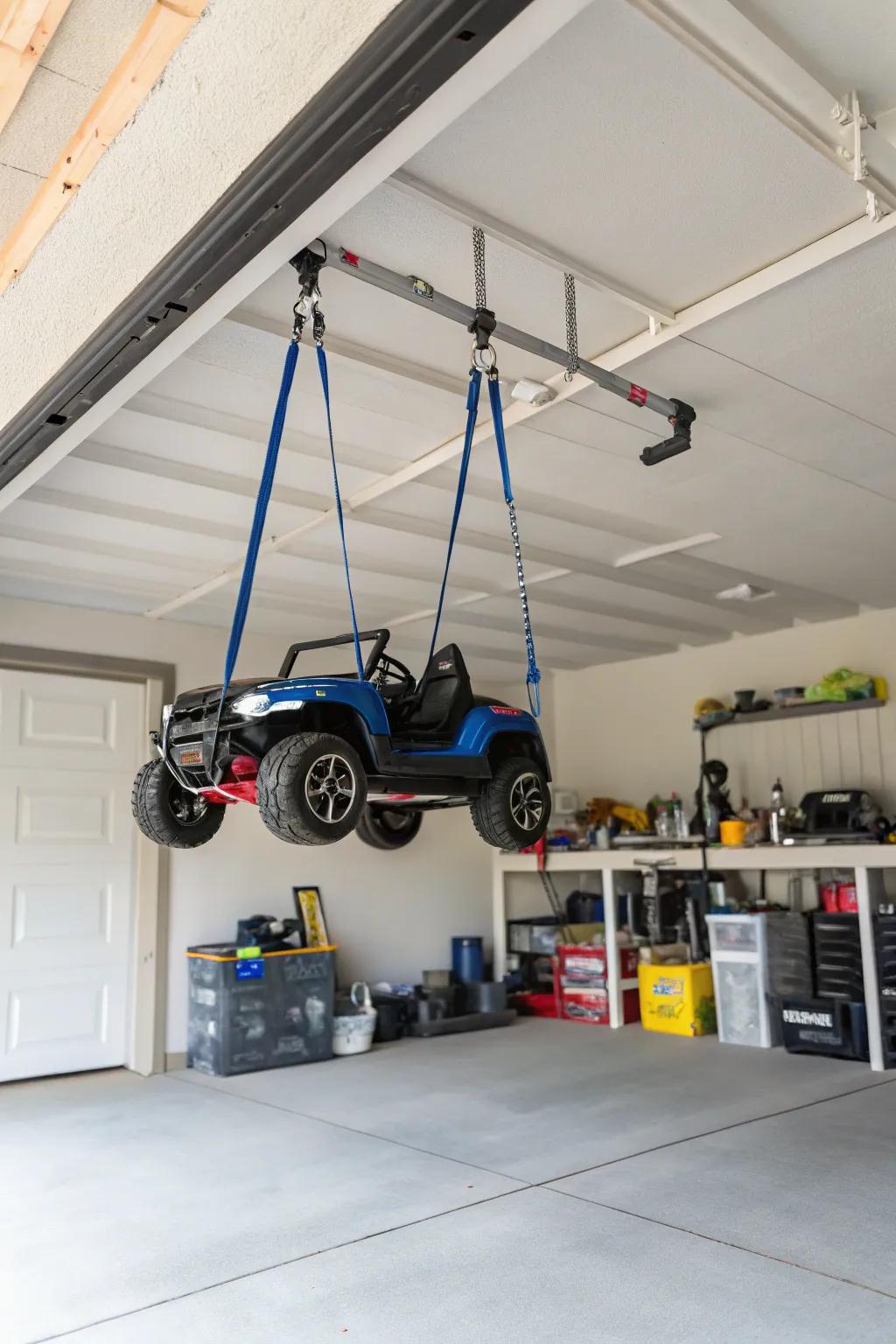 Suspension straps suspending electric ride-ons to clear floor space.