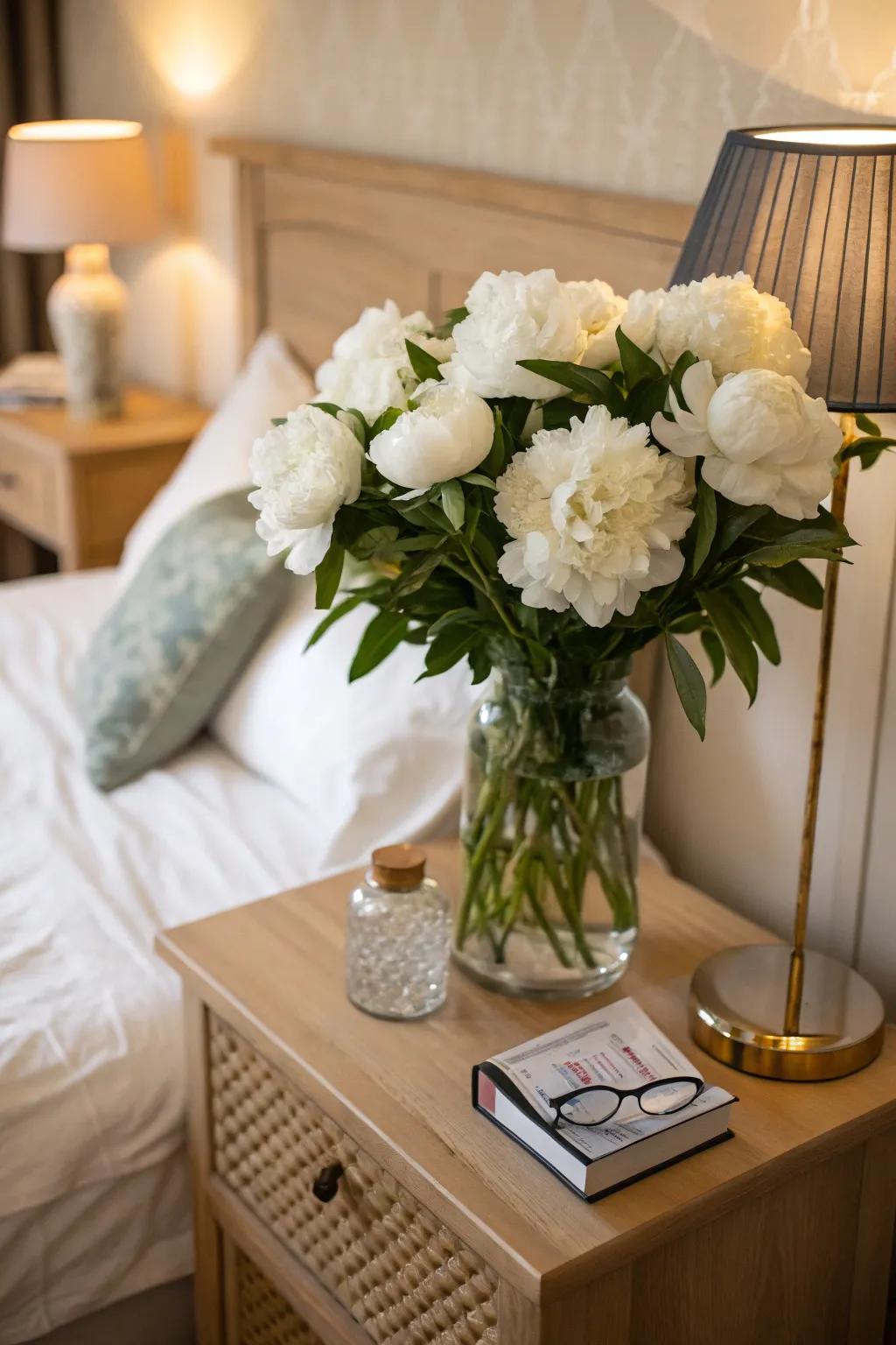 Ivory peonies imparting romance to a bedroom setting.