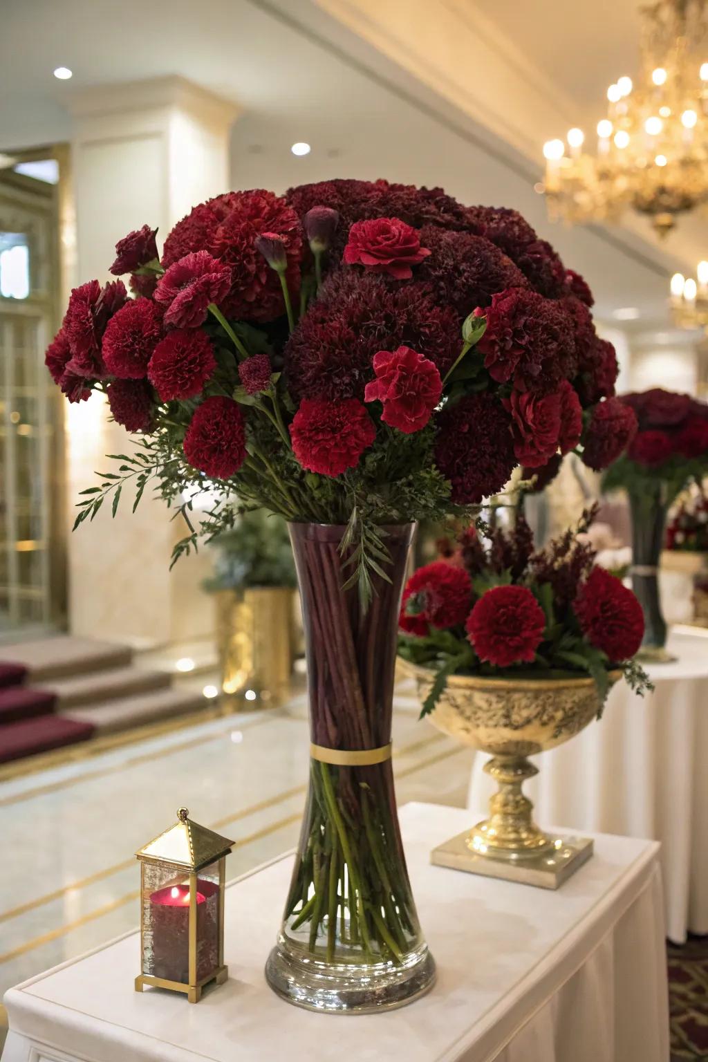 Claret carnations contribute drama and elegance to any setup.