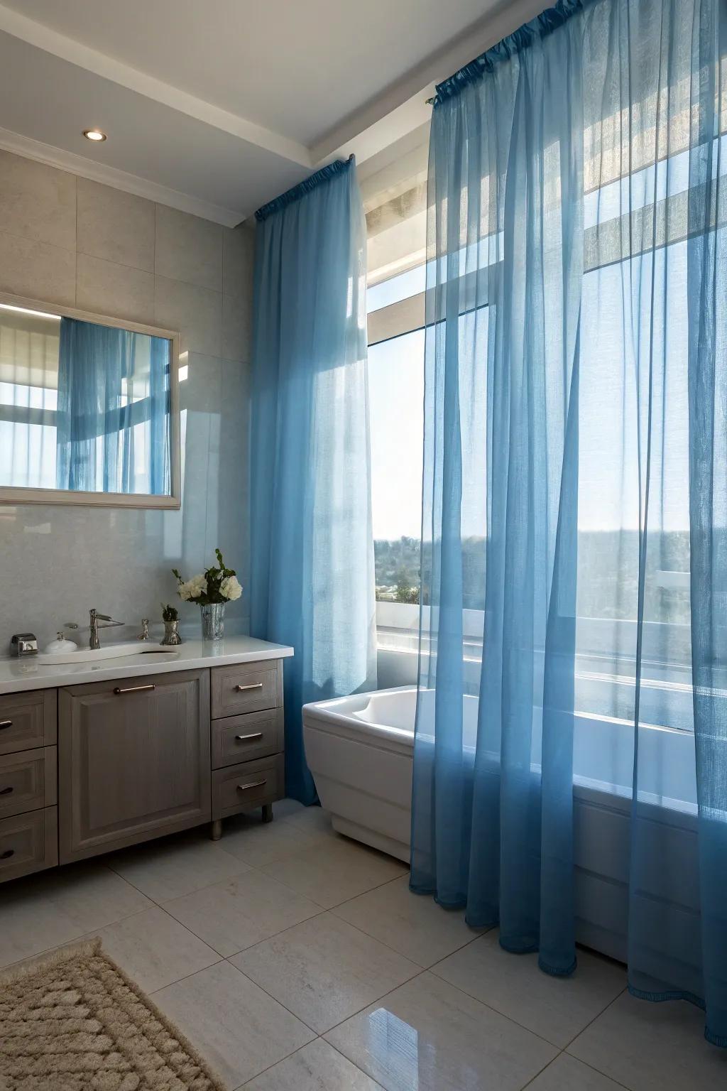 Sheer azure drapes offer seclusion while fashioning a dreamy, ethereal ambiance.