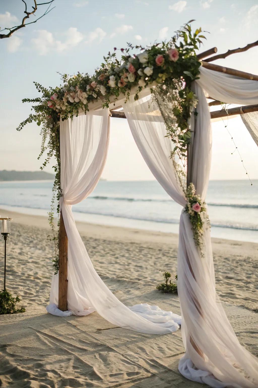 A romantic arch draped with clear cloth fluttering in the breeze.