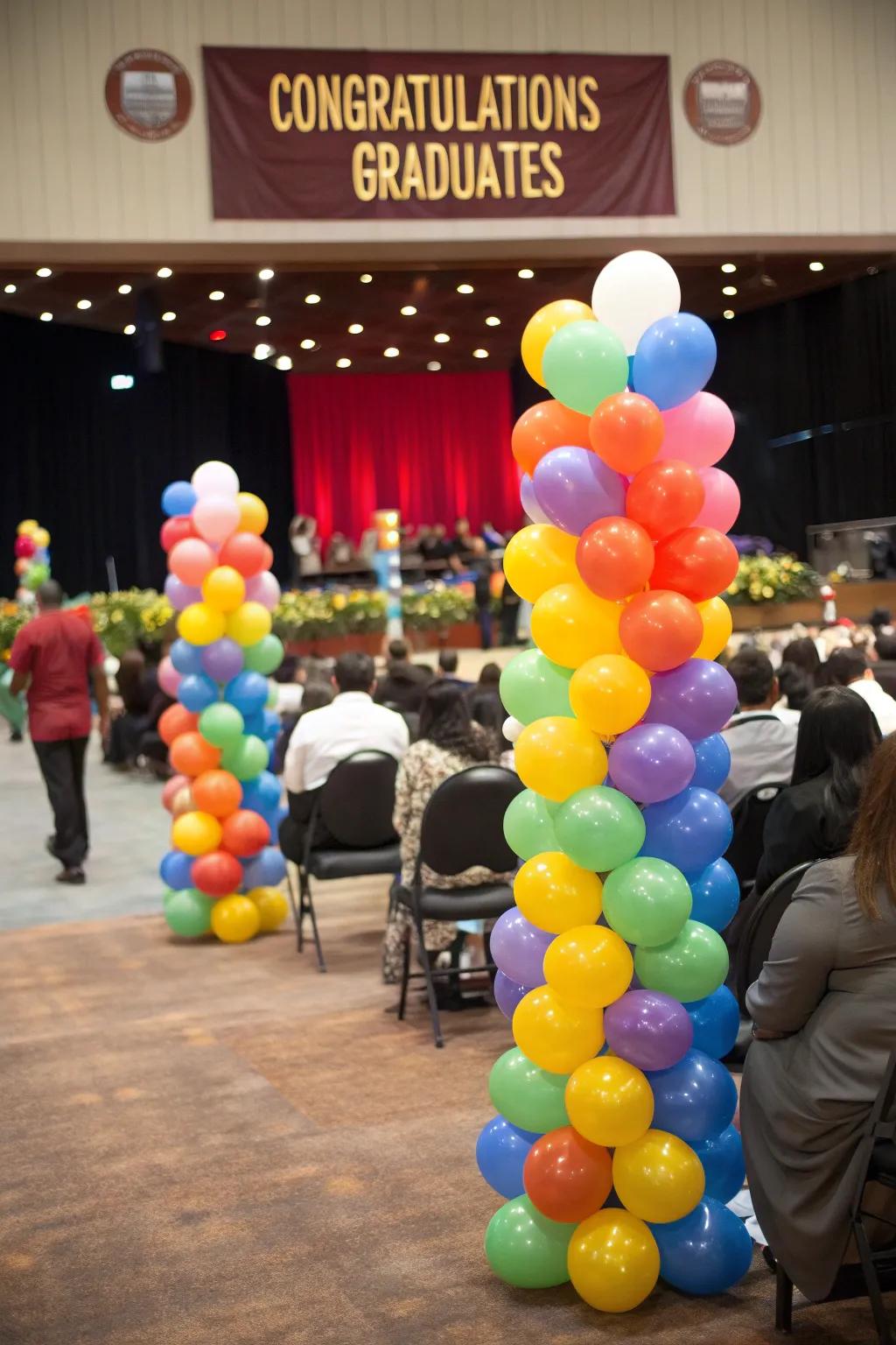 Colorful balloon sprays add vibrant décor to the graduation venue.
