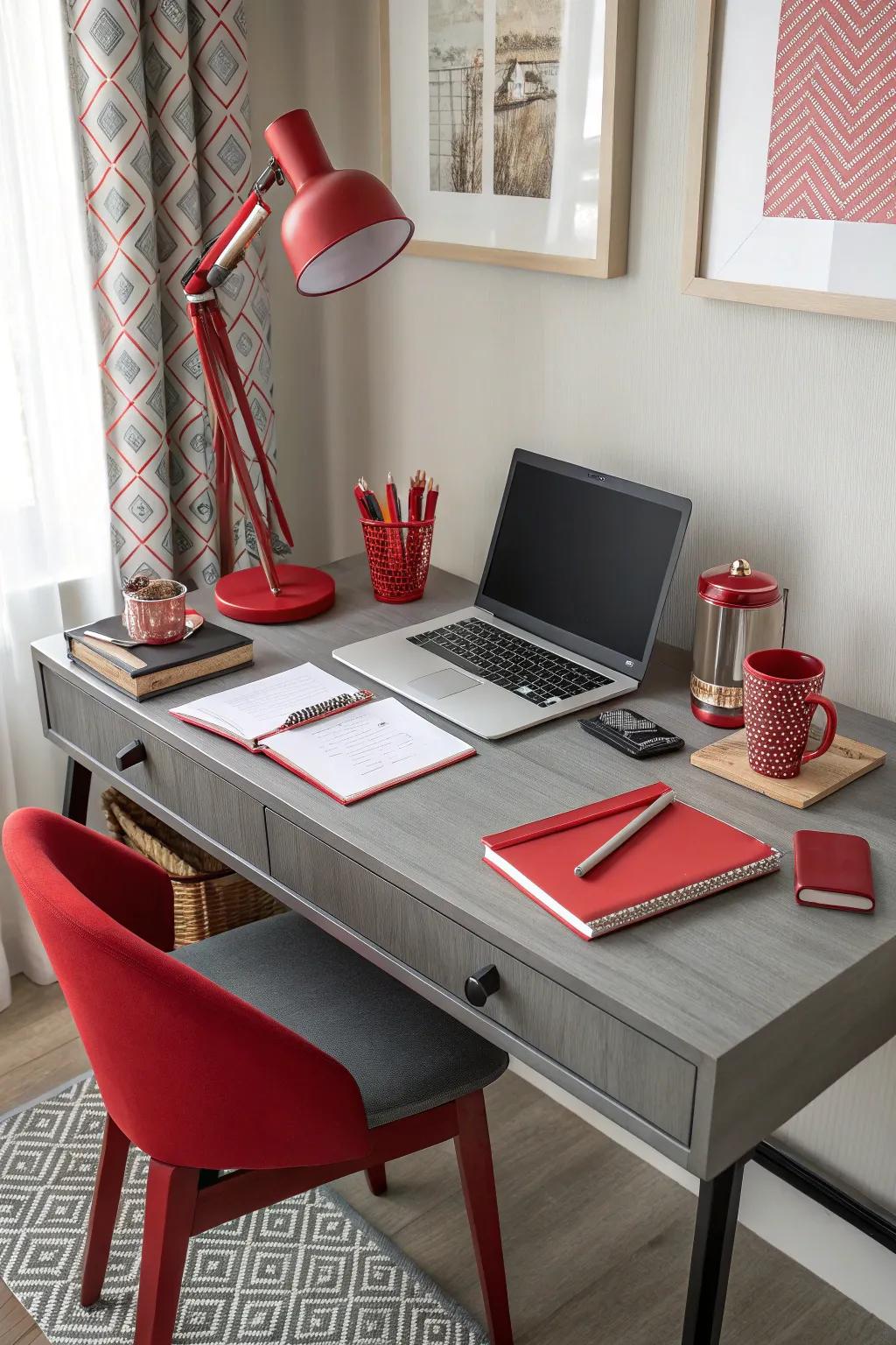 A home office featuring a grey desk and vibrant crimson accessories.