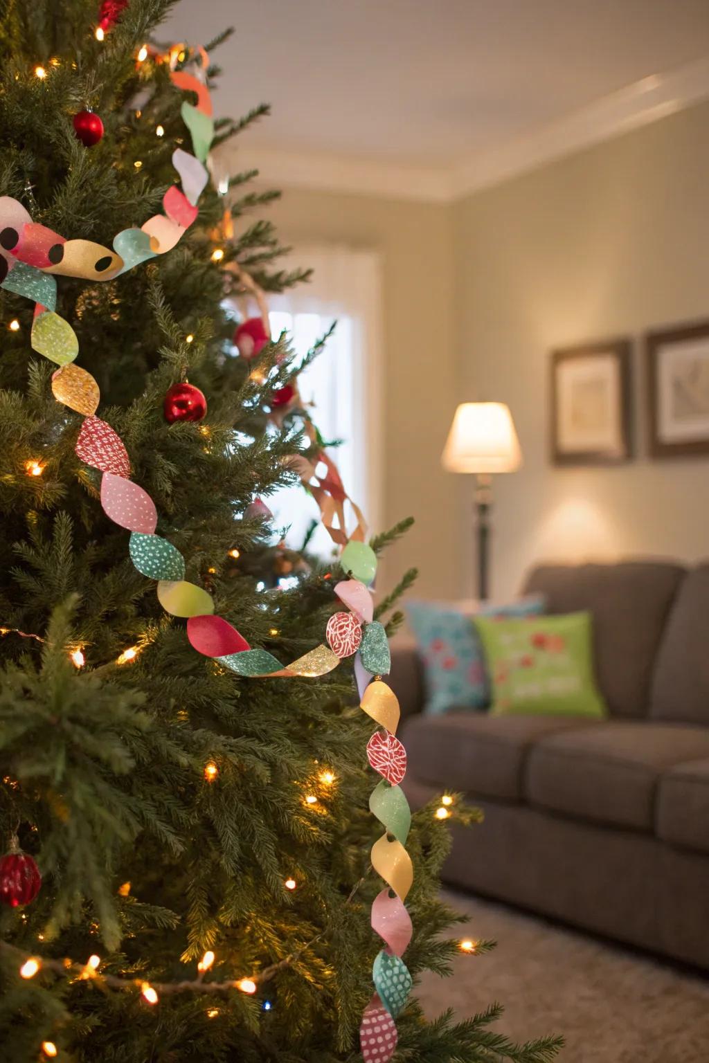 A Christmas tree adorned with a vibrant paper garland.