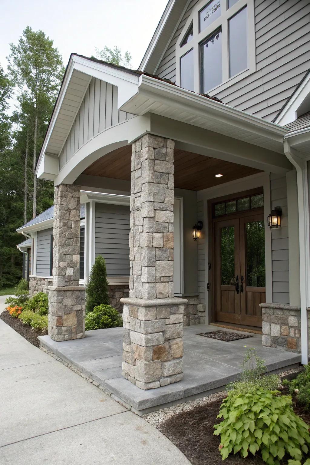 Majestic entryway featuring grey shades and stone columns.