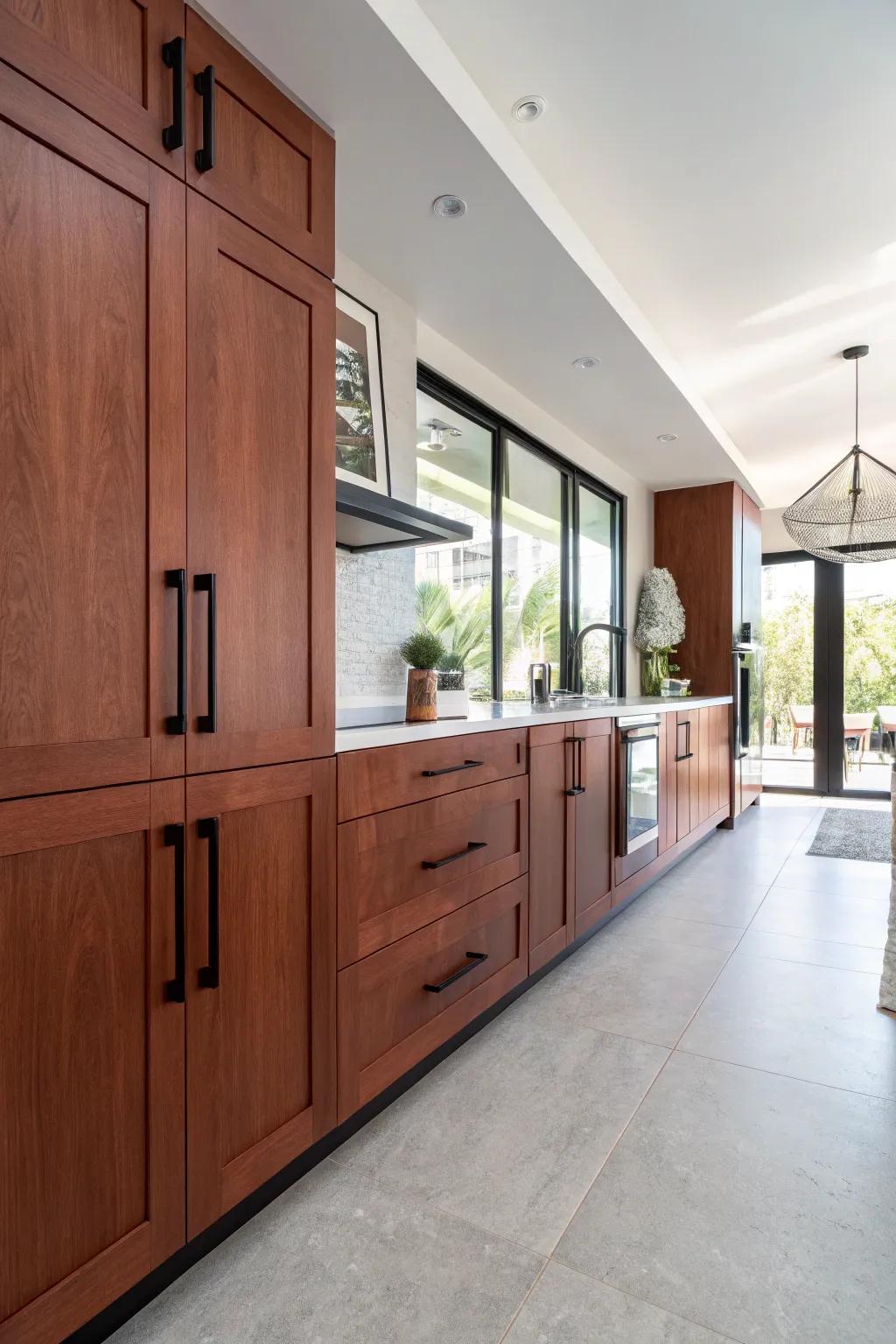 Bold black handles introduce a modern edge to cherry cabinets.