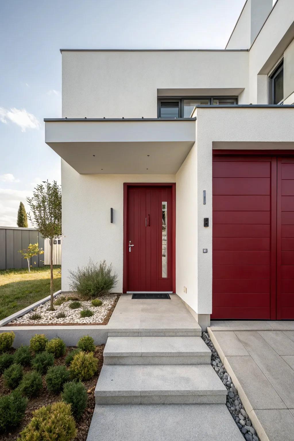 A modern residence featuring a deep scarlet door, a harmonious blend of warmth and minimalism.
