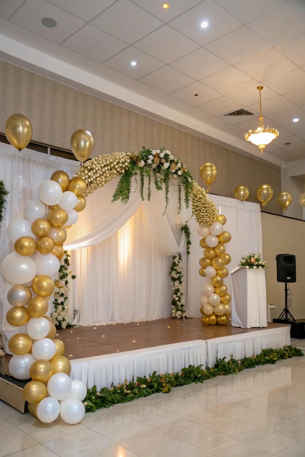 An elegant air-filled gateway and chain in gilded and alabaster framing the stage.