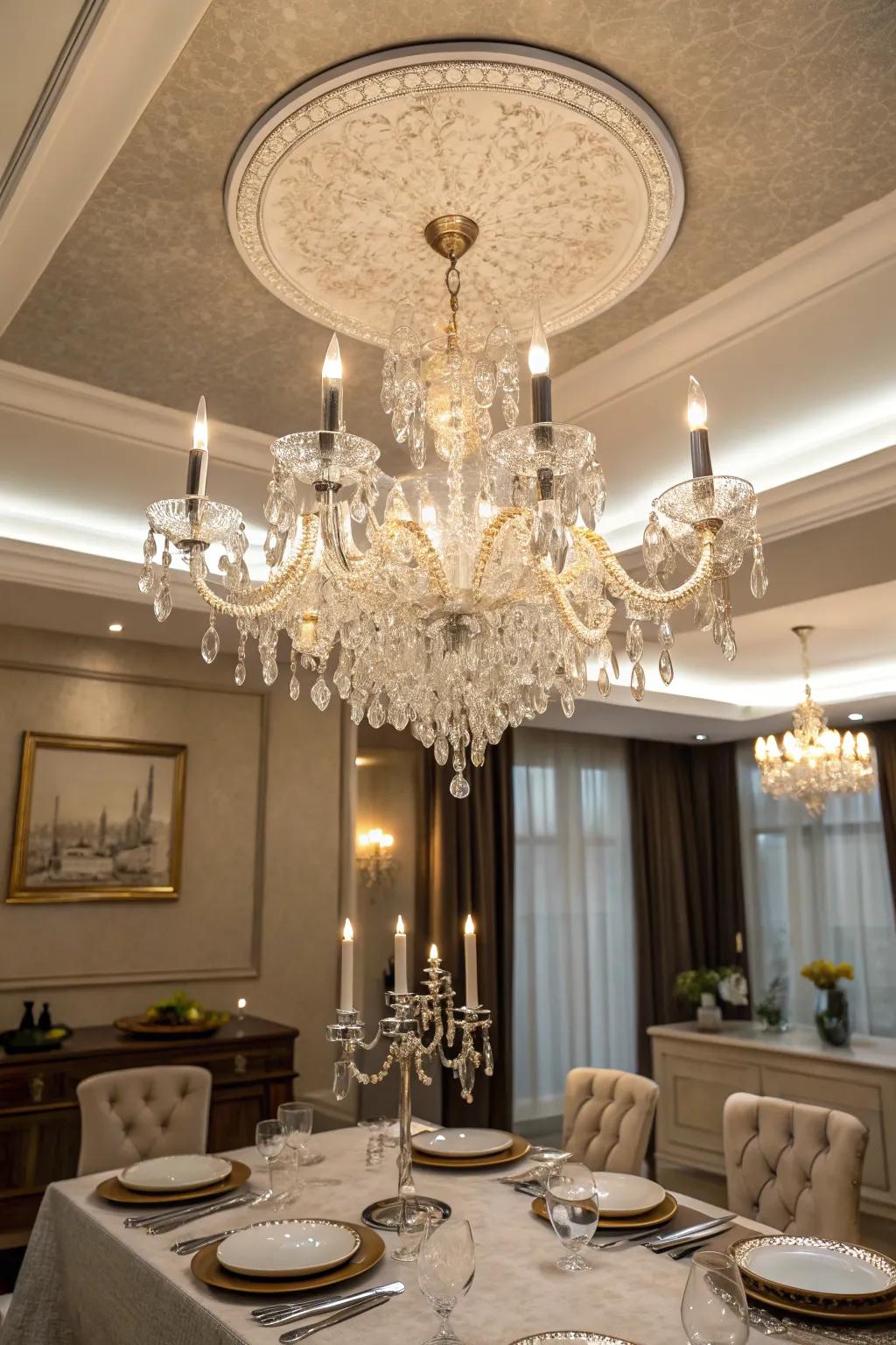 A dining space where a majestic chandelier enriches a tray ceiling with elegance.