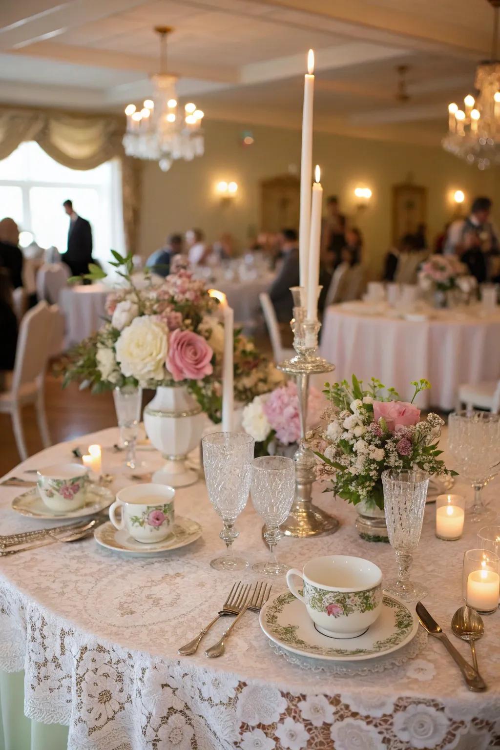 A vintage wedding table exquisitely set with sheer tablecloths.