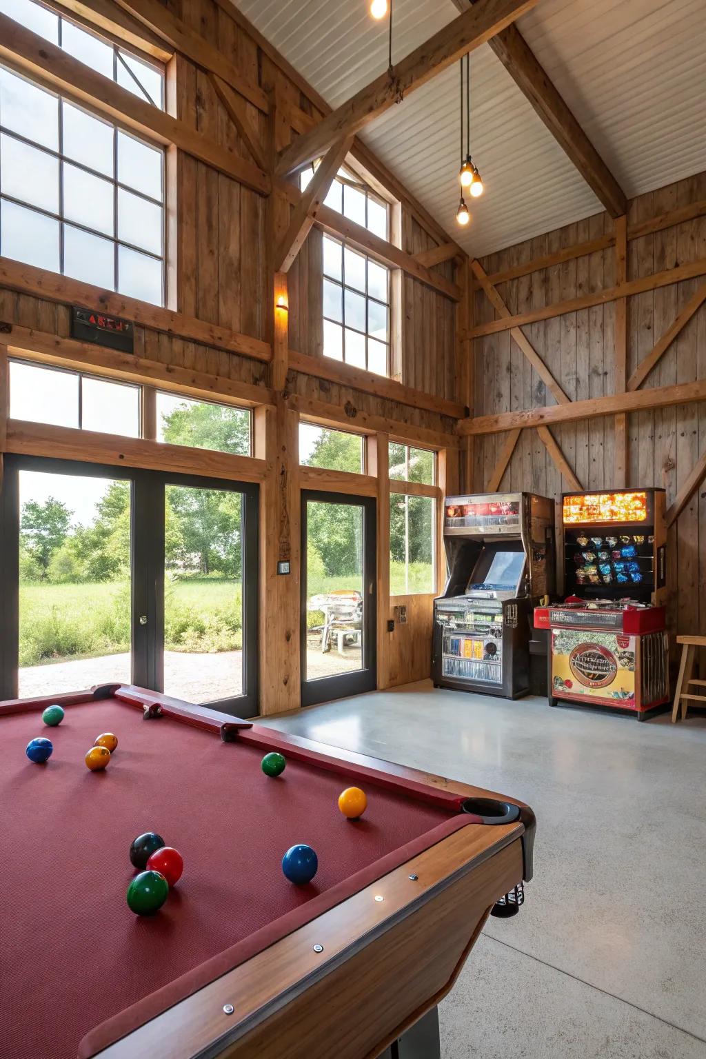 A game room inside a pole barn, with a pool table and classic play cabinets.