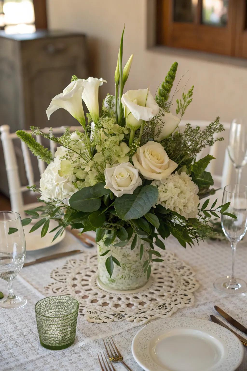 An ageless centerpiece showcasing ivory flowers and rich greenery.