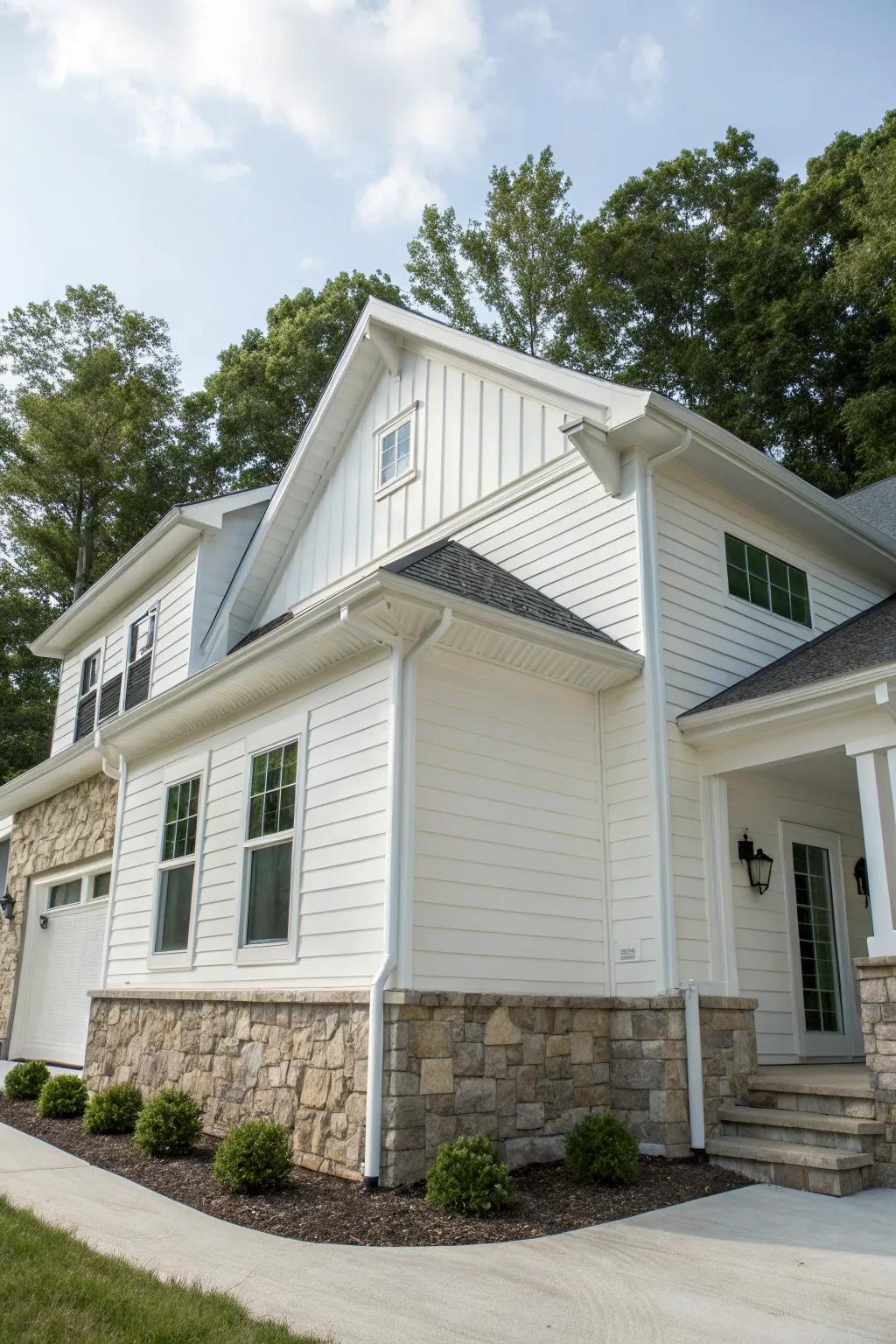 A rustic-modern house merging white vinyl siding with natural stone details.