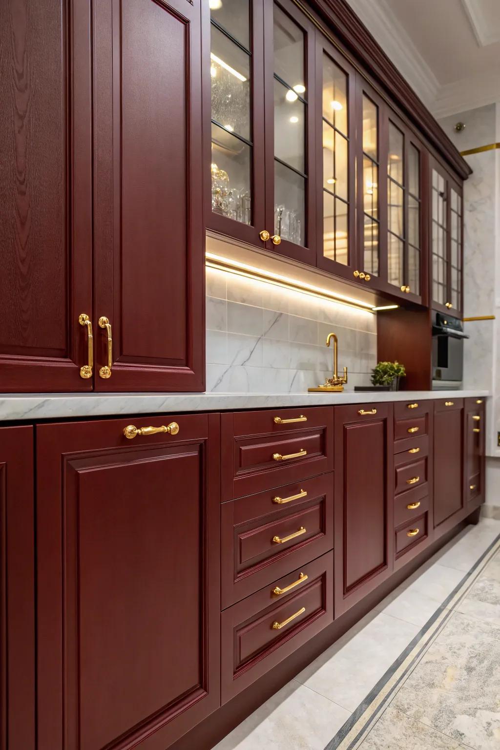 Luxurious kitchen featuring dark red cabinets and gilded details.