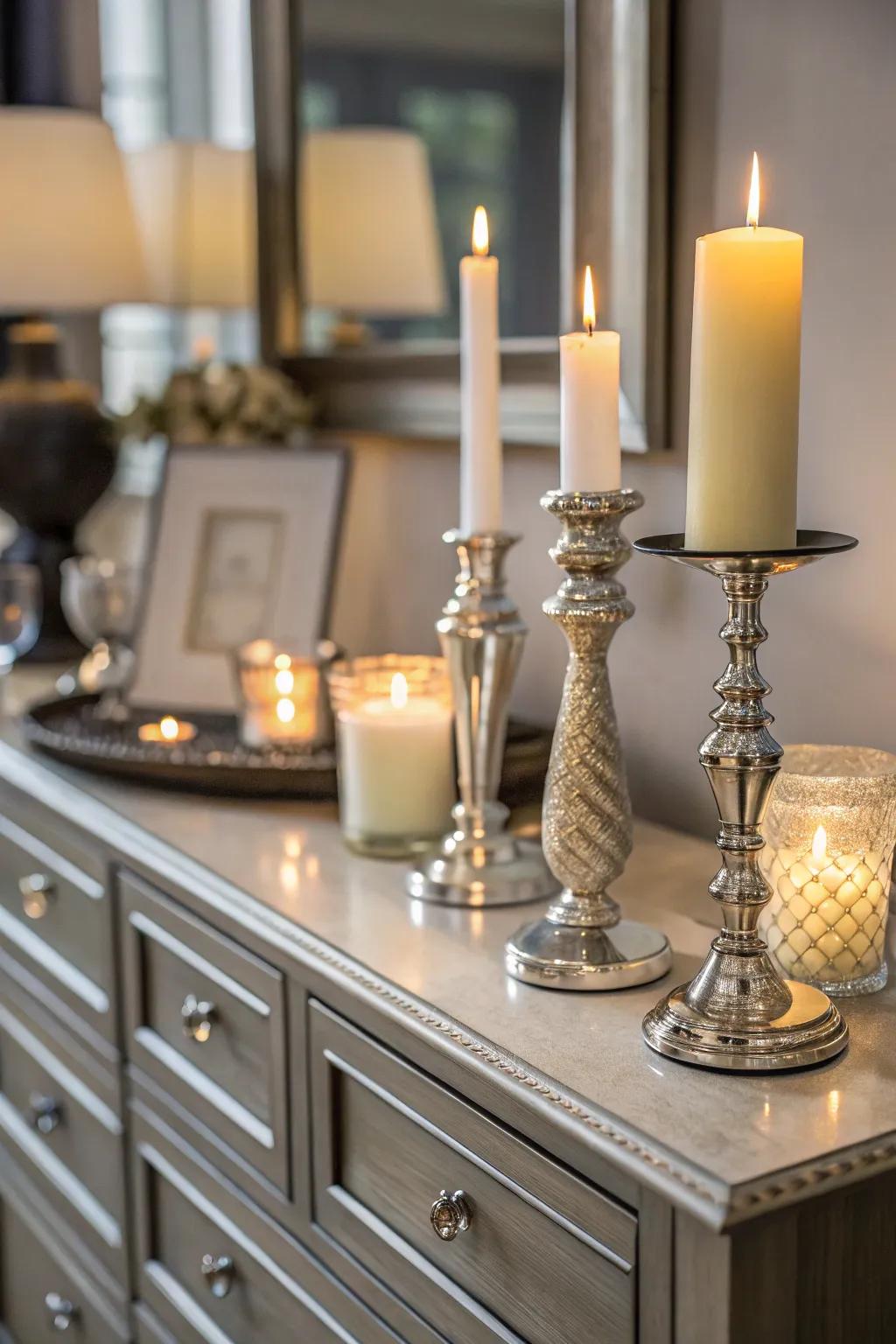 Candles introduce warmth and refinement to the dresser's aesthetic.