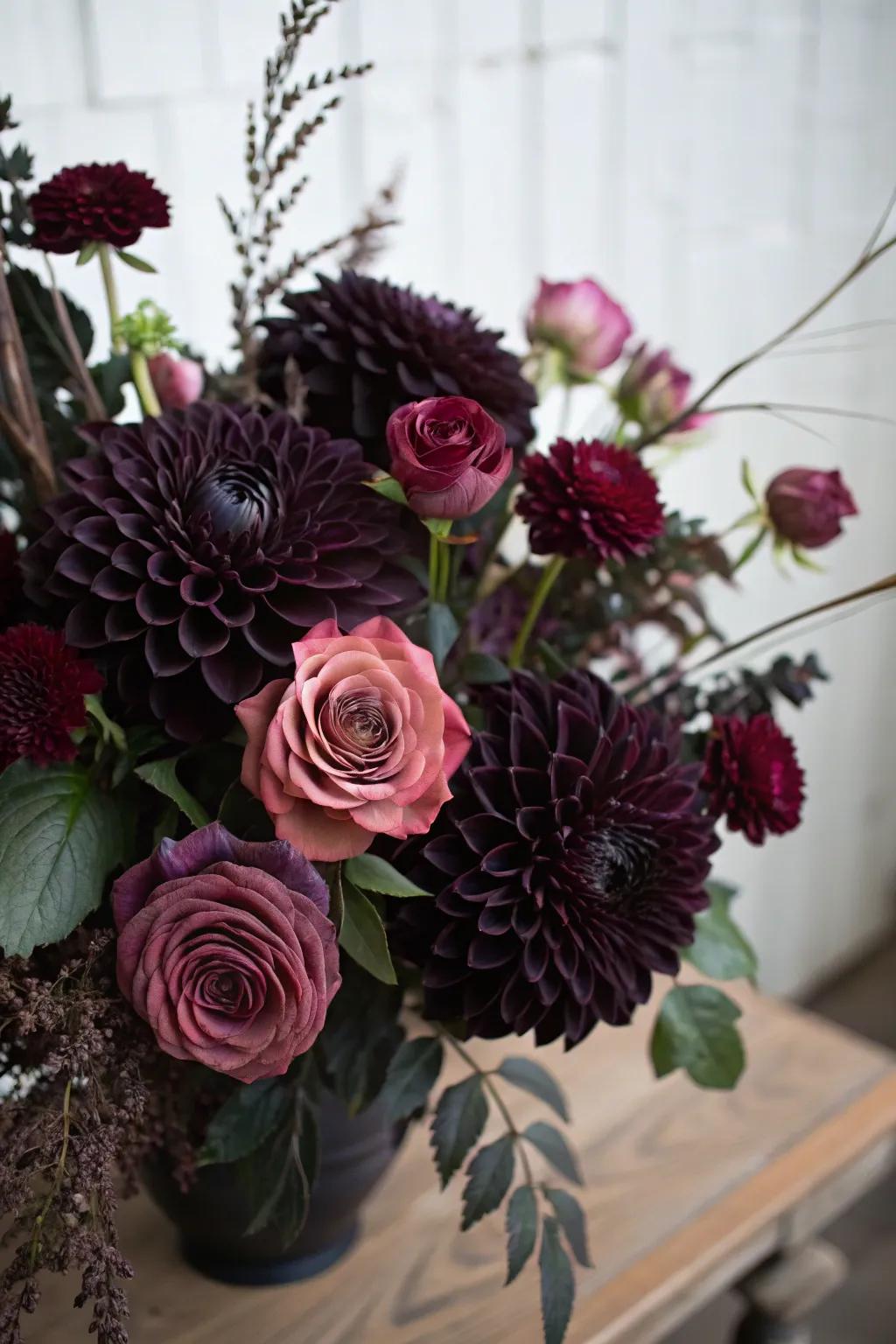 A brooding bouquet featuring sable dahlias and plum roses.