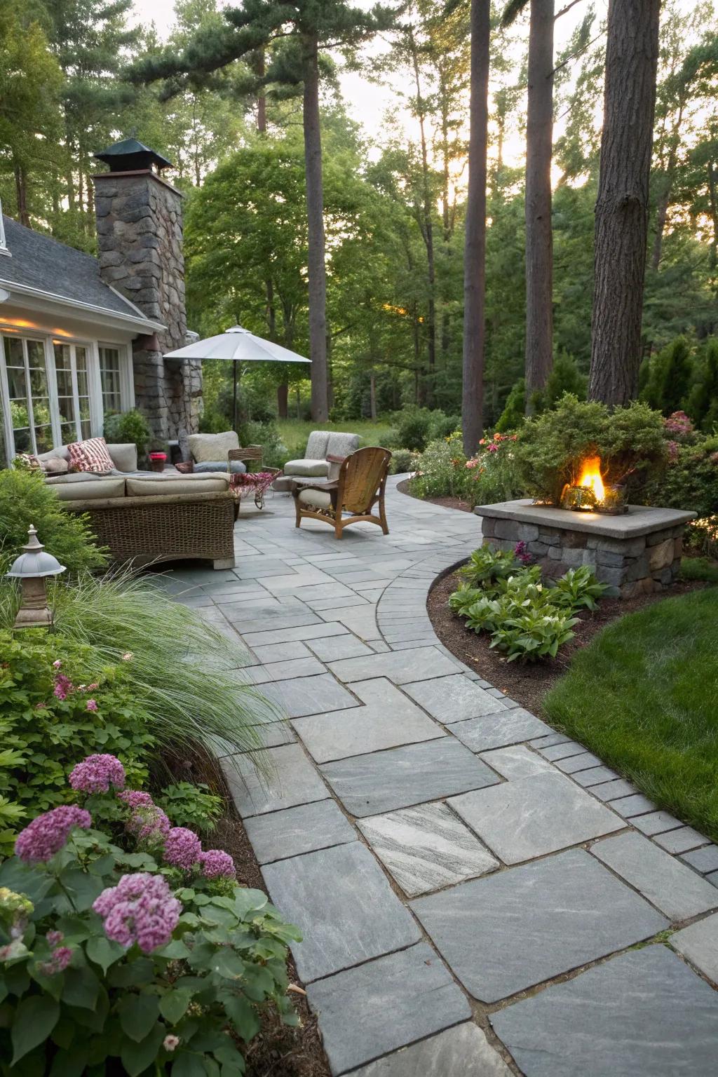 An elegant slate walkway leading toward a serene backyard retreat.