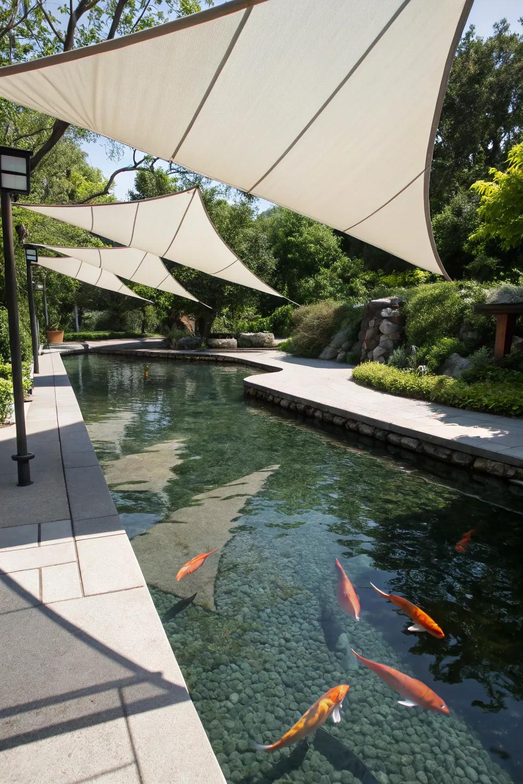 A koi pond with geometric sun sails for a sleek, modern feel.