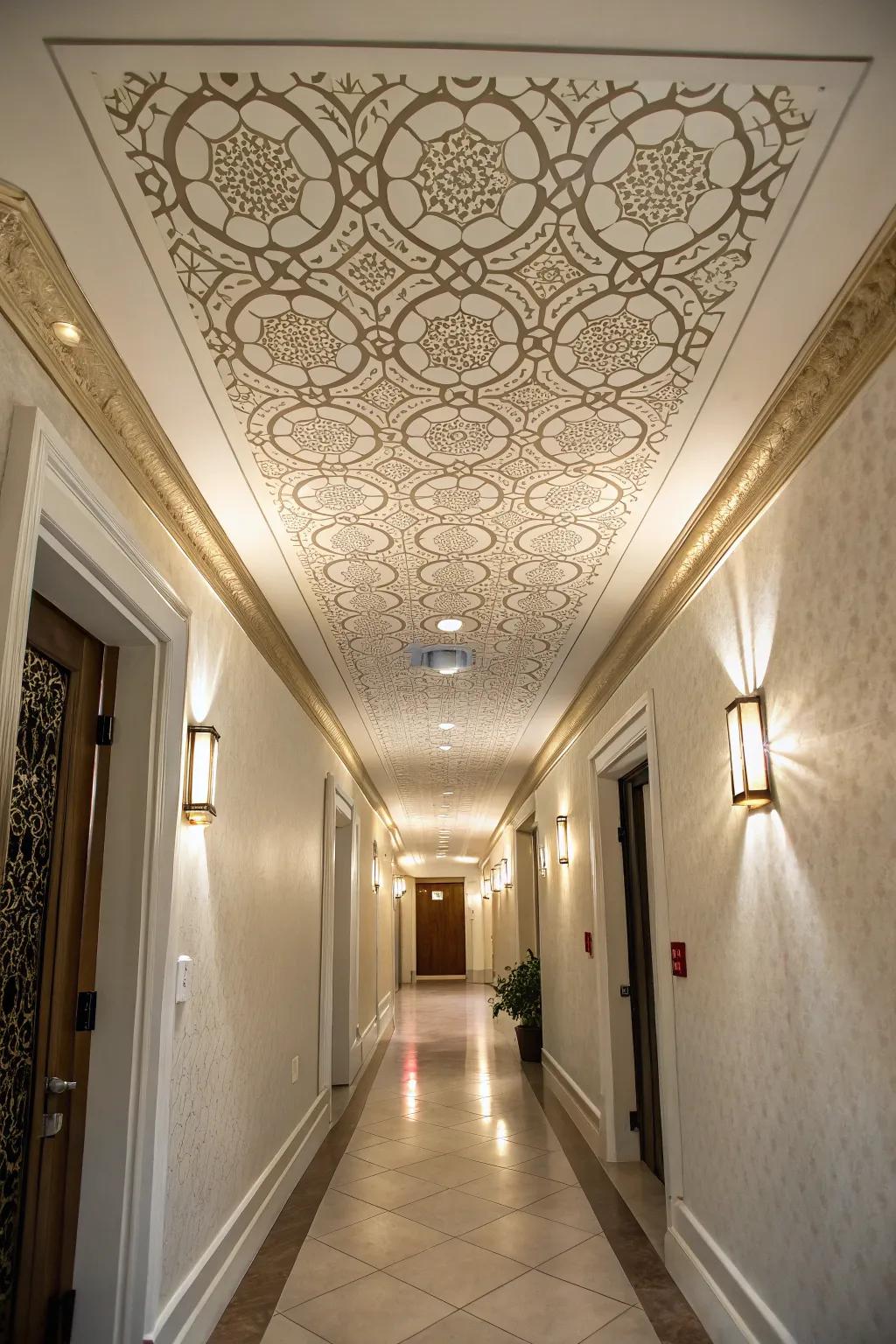 A hallway featuring a tray ceiling with a custom stenciled pattern.