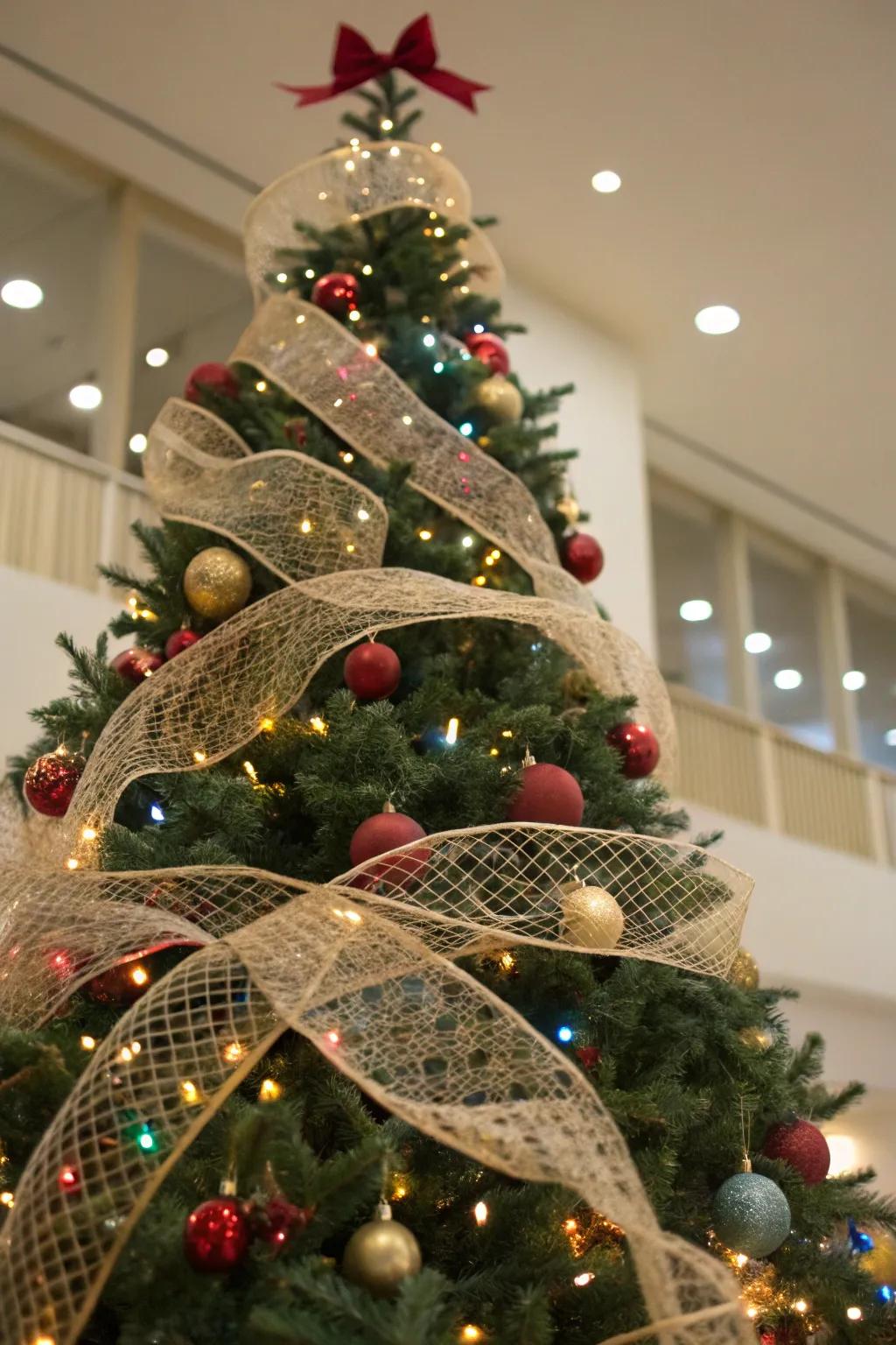 A Christmas tree with netted wraps interwoven through the branches, introducing tactile quality and dimension.