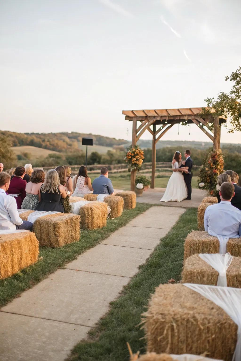 A rustic wedding ceremony with fodder bundle seating enshrouded in comfortable fabric.