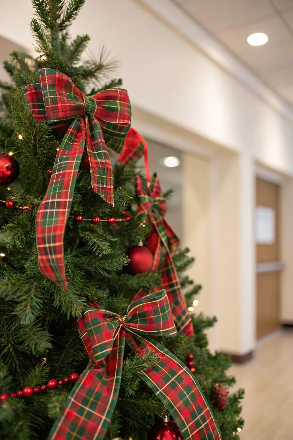 A traditional tartan-themed Christmas tree featuring red and green details.