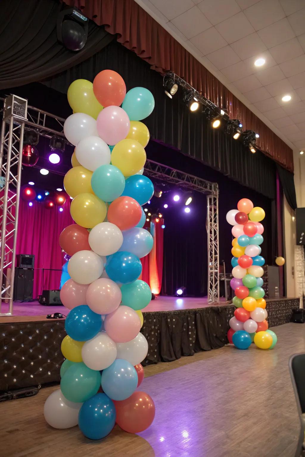 A vibrant stage setup with balloons of varying dimensions and colors.