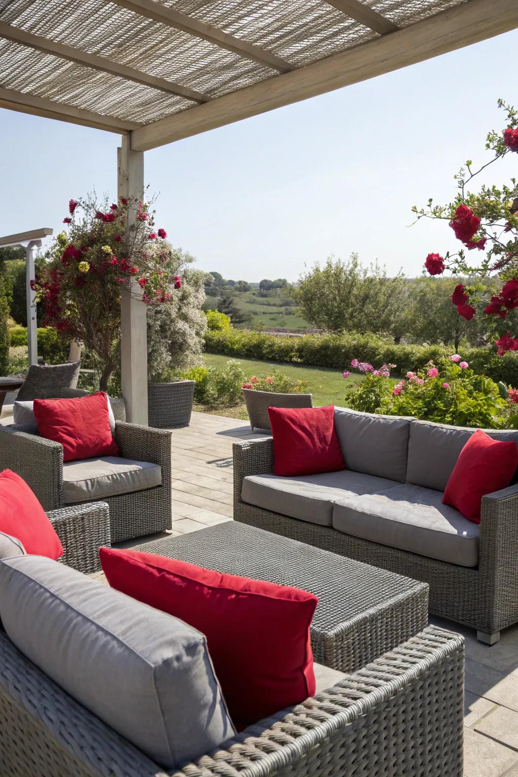 An outdoor patio featuring grey furniture and crimson cushions.