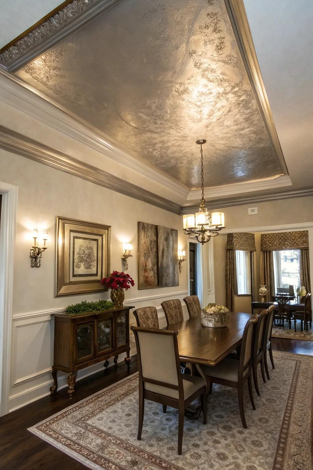 A dining room with a tray ceiling featuring a glamorous metallic finish.